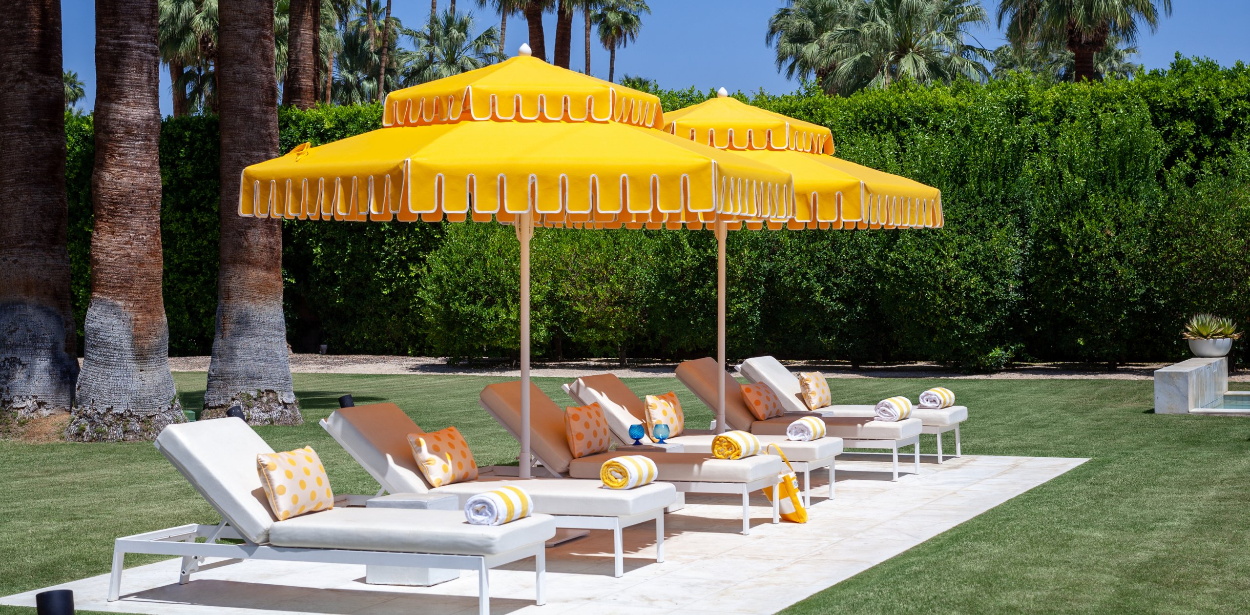 Image of umbrellas and chaises poolside